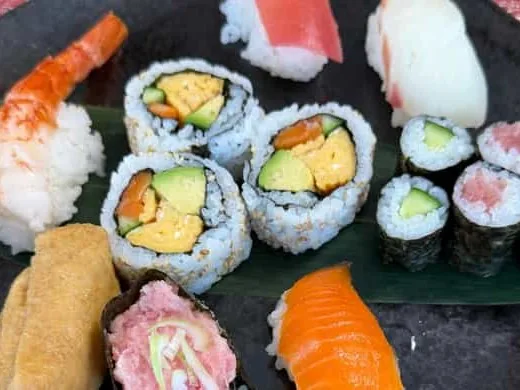 A finished plate of assorted sushi