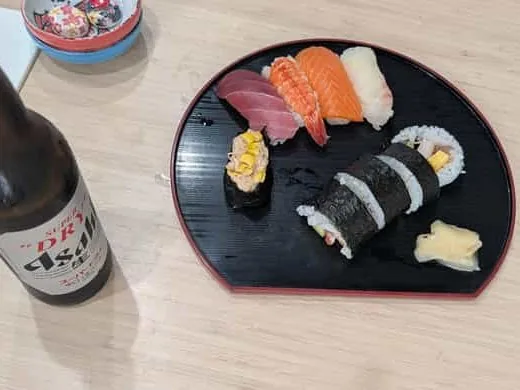Hand-rolled maki alongside fresh nigiri